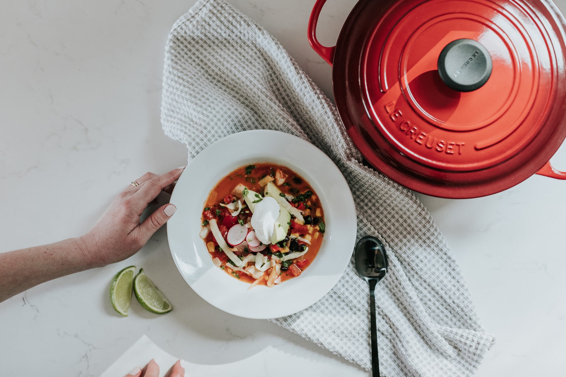 image of soup in a bowl next to a cast iron dutch oven